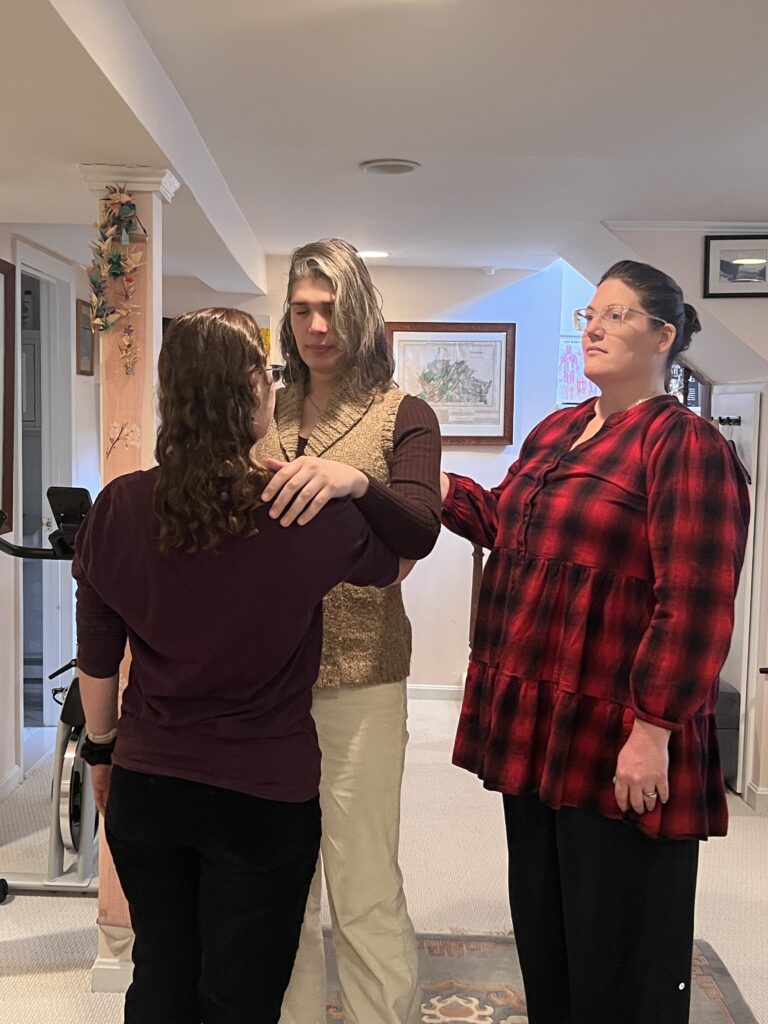 Three Alexander Technique trainees connecting through contact during Tommy Thompson’s relational support class