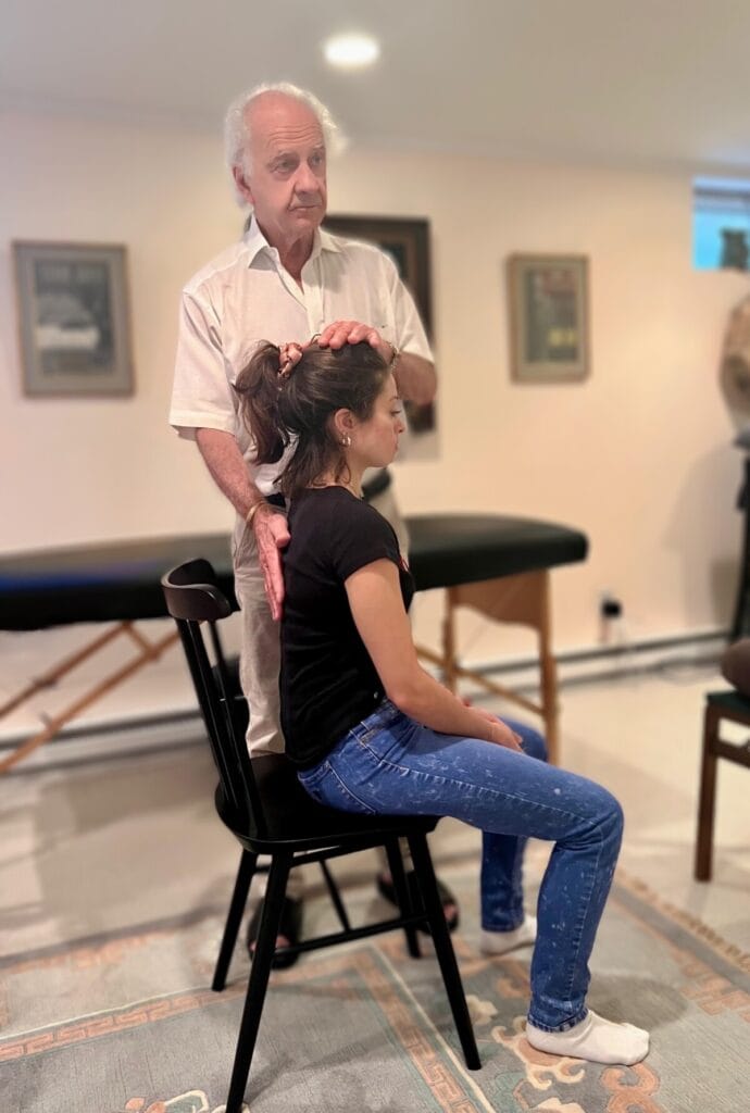 ommy Thompson applies triadic resonance and touch during an Alexander Technique session with a seated student.