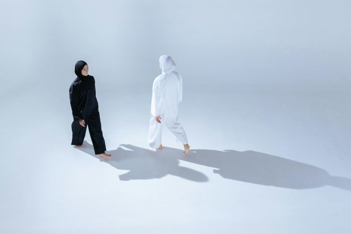 Two figures in black and white facing each other in motion, symbolizing internal conflict and the duality of movement identity in the Alexander Technique.