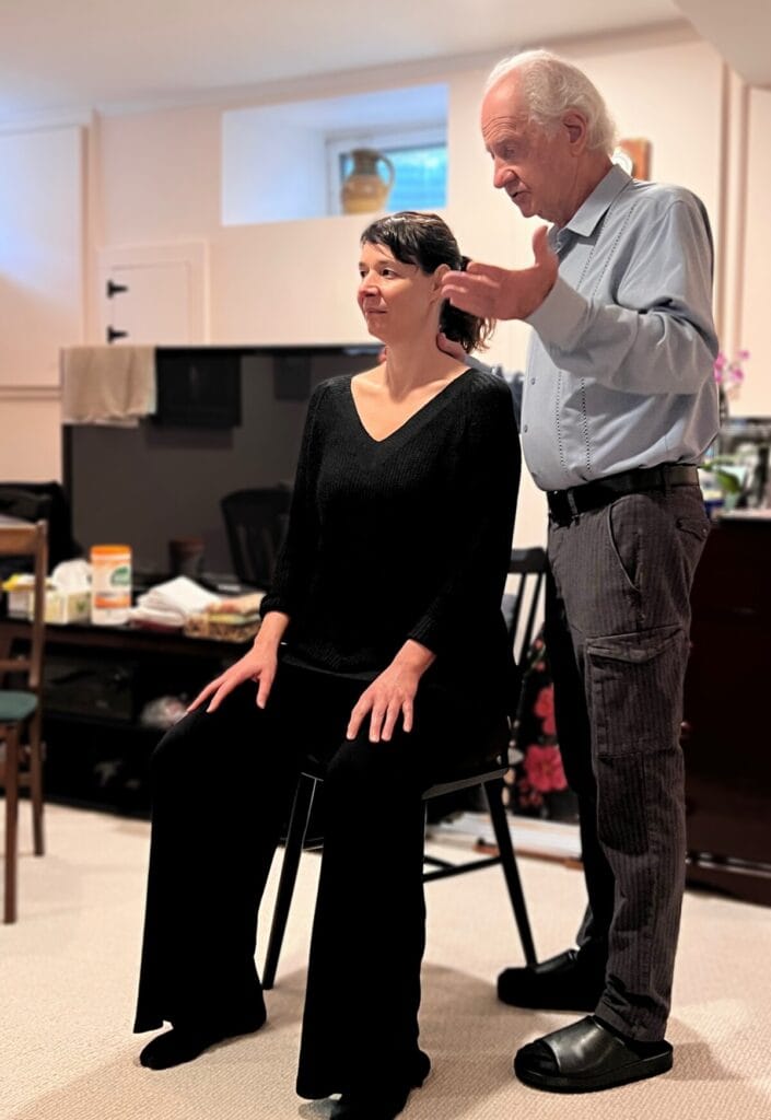 Trainee in seated position during an Alexander Technique class, receiving embodied awareness instruction from Tommy Thompson
