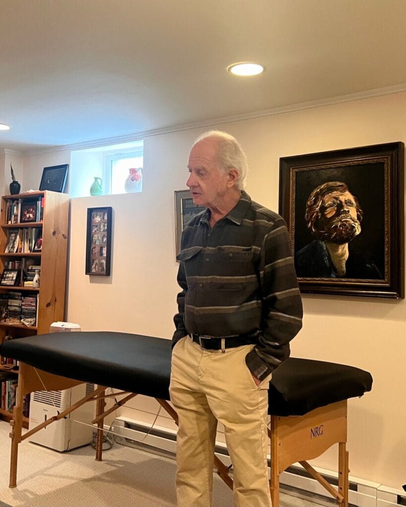 Tommy Thompson stands in the Alexander Technique classroom, preparing to guide trainees into embodied awareness during presence class.