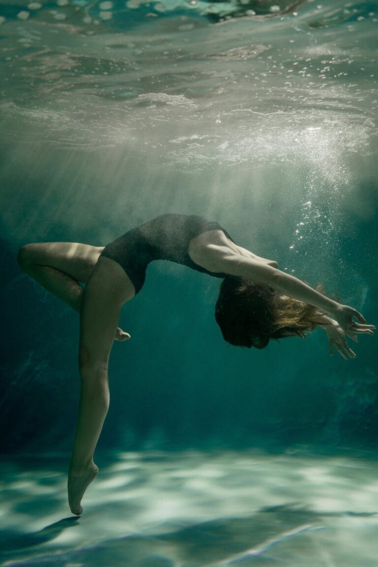 A dancer suspended underwater expressing the Still Point in embodied movement through the Alexander Technique