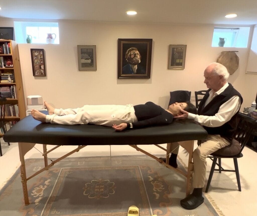 Tommy Thompson guiding a trainee during an Alexander Technique class, illustrating hands-on application of Triadic Resonance.