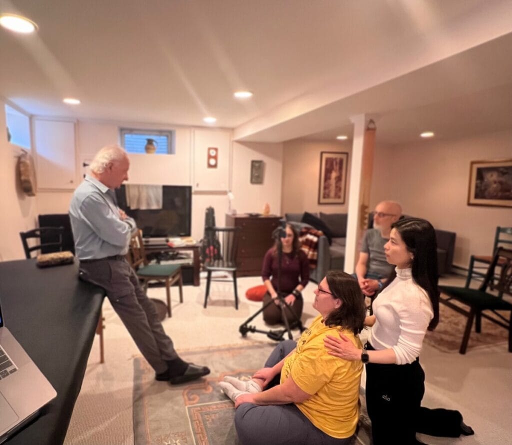 Tommy Thompson stands in front of trainees during an Alexander Technique class, introducing use as a reflection of identity