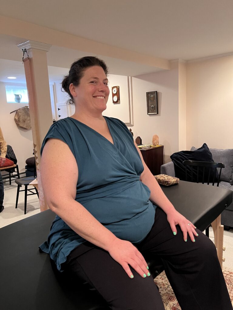 Trainee Lili sitting and smiling after her Alexander Technique Class 51 experience, embodying quiet transformation and presence
