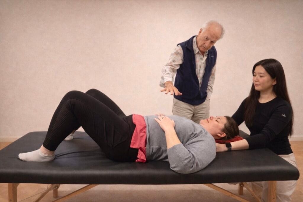 Alexander Technique class 104 with Tommy Thompson demonstrating withholding-definition through hands-on guidance with trainees